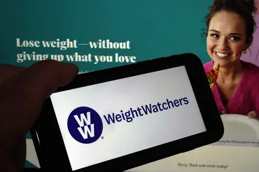 This image shows the logo of WeightWatchers on a mobile phone, and the company's website, in New York, Tuesday, March 7, 2023. (AP Photo/Richard Drew, File)