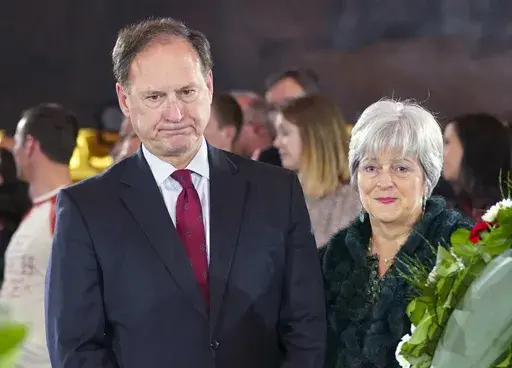Supreme Court Justice Samuel Alito Jr., left, and his wife Martha-Ann Alito, pay their respects at the casket of Reverend Billy Graham at the Rotunda of the U.S. Capitol Building in Washington, Feb. 28, 2018. Alito rejects calls to step aside from Supreme Court cases on Trump and Jan. 6. (AP Photo/Pablo Martinez Monsivais, File)