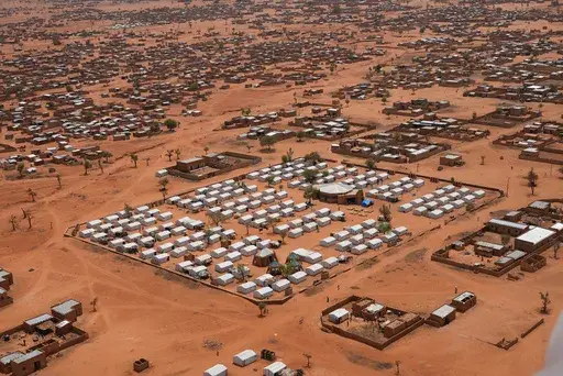 FILE- An aerial view shows a camp of internally displaced people in Djibo, Burkina Faso, May 26, 2022. Videos published by the state-run RTB Television Tuesday, Nov, 28, 2023, showed large groups of people riding motorcycles around a swathe of desert land as they appeared to be running from aerial bombardments. It was not immediately clear the number of civilians and security forces killed during the Sunday attack near Mali's border and involving about 3,000 rebels, according to the broadcaster.