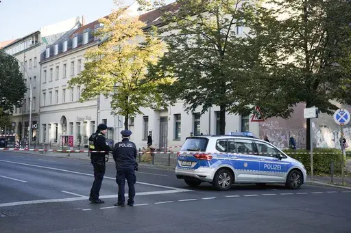 German police officers stand guard in front of the building complex of the Kahal Adass Jisroel community, which houses a synagogue, a kindergarten and a community center, in the center of Berlin, Germany, Wednesday, Oct. 18, 2023. European Union interior ministers met Thursday, Oct. 19, 2023, to discuss how to manage the impact of the war between Israel and Hamas on the bloc, after a firebomb assault on a Berlin synagogue and killings in Belgium and France by suspected Islamist extremists. (AP P