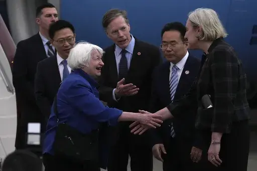 U.S. Treasury Secretary Janet Yellen, left, shakes hands with Lisa Heller, U.S. Consul for Guangzhou after arriving at Guangzhou Baiyun Airport in southern China's Guangdong province, Thursday, April 4, 2024. Treasury Secretary Janet Yellen is heading to a China that is determined to avoid open conflict with the United States. (AP Photo/Andy Wong, Pool)