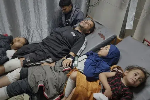 Injured Palestinians wait for treatment at the hospital following Israeli army airstrikes in Khan Younis, southern Gaza Strip, Tuesday, March 18, 2025. (AP Photo/Mohammad Jahjouh)