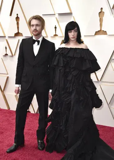 Finneas, left, and Billie Eilish arrive at the Oscars on March 27, 2022, at the Dolby Theatre in Los Angeles. Ukrainian President Volodymyr Zelenskyy’s call for humanitarian help has been answered by the European Commission, the government of Canada and dozens of celebrities assembled by advocacy nonprofit Global Citizen, including Oscar winners Billie Eilish and Finneas. (Photo by Jordan Strauss/Invision/AP)