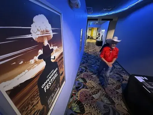 Downwinder Paul Pino heads through the SALA Event Center toward the screening of "First We Bombed New Mexico" during the Oppenheimer Film Festival in Los Alamos, New Mexico on Saturday, Aug. 17, 2024. The documentary tells the stories of those who lived near the Trinity Test Site when the U.S. government detonated the first atomic bomb and the Native Americans who worked in the uranium industry. (AP Photo/Susan Montoya Bryan)