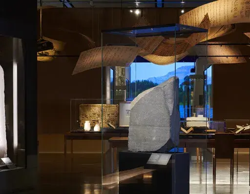 This undated photo provided by the British Museum, shows the Rosetta Stone, the centerpiece of a new exhibition at London’s largest museum titled, "Hieroglyphs unlocking ancient Egypt," celebrating the 200th anniversary of the stone's decipherment, at the British Museum, in London. Thousands of Egyptians are demanding that the British Museum return the Rosetta stone. The bilingual carvings on the stone proved to be the breakthrough in the decipherment of ancient Egyptian hieroglyphics after be