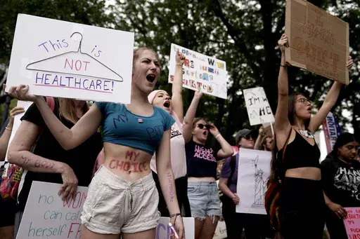 People rally in support of abortion rights, July 2, 2022, in Kansas City, Mo. A divide between abortion rights activists over whether to include restrictions related to the viability of the fetus on planned state ballot measures is roiling the movement. The conflict has been especially divisive in Missouri, where conflicting strategies are complicating efforts to push ahead with a ballot measure in a state with one of the nation's strictest abortion bans. (AP Photo/Charlie Riedel, File)