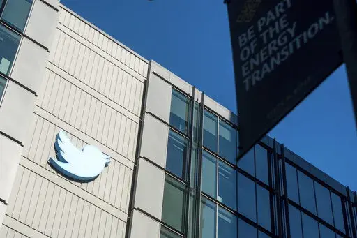 A Twitter logo hangs outside the company's San Francisco offices on Nov. 1, 2022. A top European Union official warned Elon Musk on Wednesday Nov. 30, 2022 that Twitter needs to beef up measures to protect users from hate speech, misinformation and other harmful content to avoid violating new rules that threaten tech giants with big fines or even a ban in the 27-nation bloc. (AP Photo/Noah Berger, File)