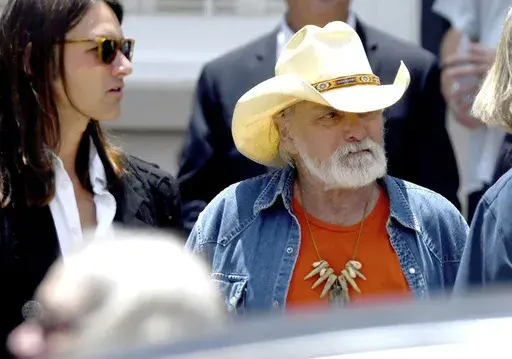 Dickey Betts, a founding member of the Allman Brothers Band, exits the funeral of Gregg Allman at Snow's Memorial Chapel, June 3, 2017, in Macon, Ga. Guitar legend Betts, who co-founded the Allman Brothers Band and wrote their biggest hit, “Ramblin’ Man,” died Thursday, April 18, 2024. He was 80. (Jason Vorhees/The Macon Telegraph via AP, File)