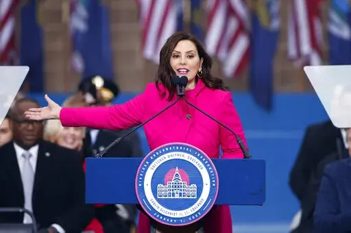 Michigan Gov. Gretchen Whitmer addresses the crowd during inauguration ceremonies, Sunday, Jan. 1, 2023, outside the state Capitol in Lansing, Mich. (AP Photo/Al Goldis)