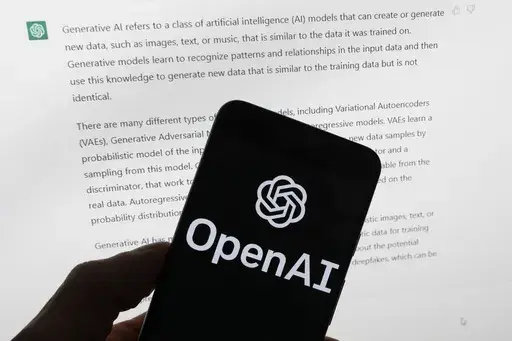The OpenAI logo is seen on a mobile phone in front of a computer screen displaying output from ChatGPT, March 21, 2023, in Boston. Digital news outlets The Intercept, Raw Story and AlterNet are joining the fight against unauthorized use of their journalism in artificial intelligence, filing a copyright-infringement lawsuit Wednesday, Feb. 28, 2024, against ChatGPT owner OpenAI. (AP Photo/Michael Dwyer, File)