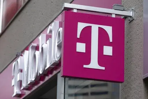 The T-Mobile logo is seen on a storefront, on Oct. 14, 2022, in Boston. Customers of the wireless provider reported widespread service outages in the U.S. late Monday, Feb. 13, 2023, according to websites tracking service interruptions. (AP Photo/Michael Dwyer, File)